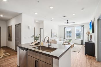 a kitchen with an island and a living room with a couch at Stella Luxury Apartment Homes, San Tan Valley